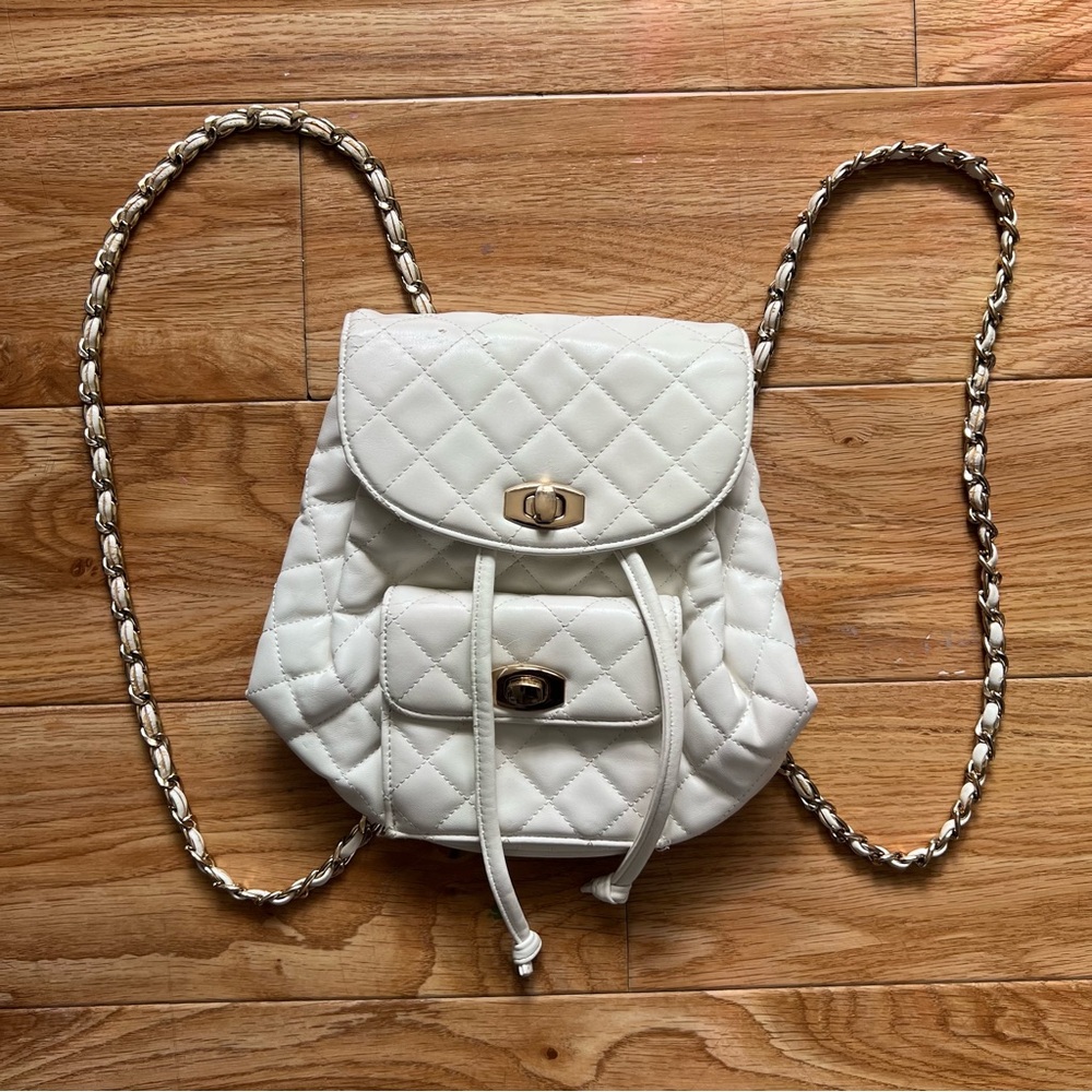 Small White Quilted Backpack with Chain Straps and Drawstring Closure